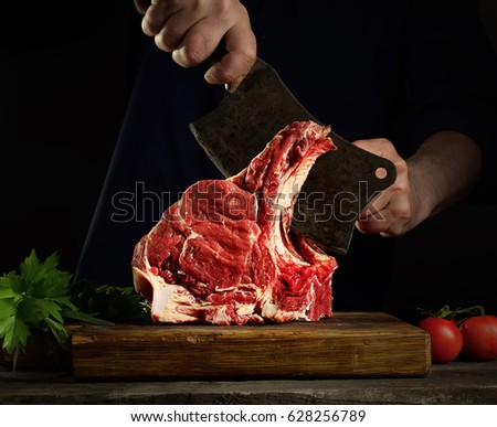 Man cutting raw beef meat. Royalty-Free Stock Photo #628256789