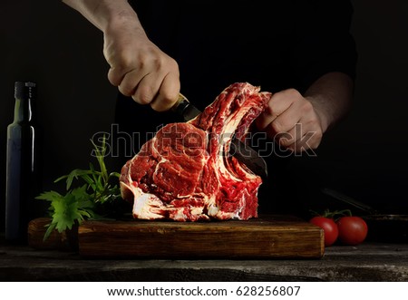 Man cutting raw beef meat. Royalty-Free Stock Photo #628256807