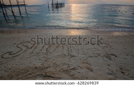Word “ SUMMER “ Write in sand on the beach  .