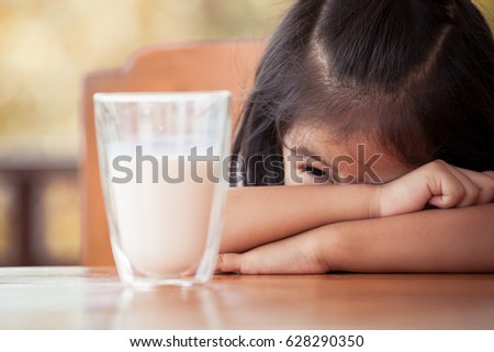 Asian little girl don't need to drink milk with a glass of milk in vintage color tone