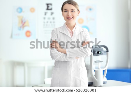 Female ophthalmologist with crossed arms in clinic Royalty-Free Stock Photo #628328381