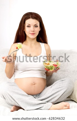 Pregnant woman eats a salad