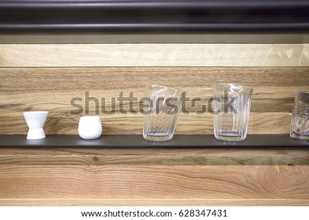strange soft transparent glasses on the shelf at the wooden background