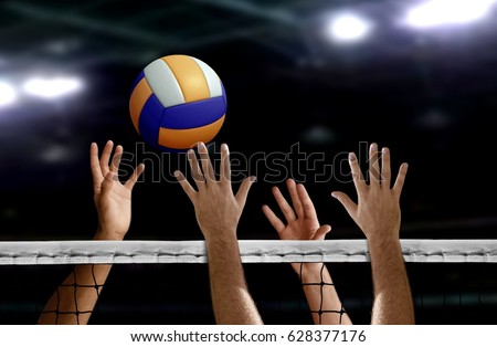 Volleyball spike hand block over the net Royalty-Free Stock Photo #628377176