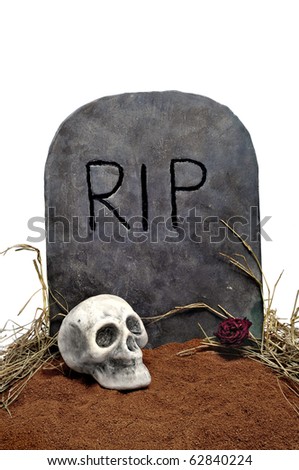 closeup of a grave with a skull in a cemetery for Halloween