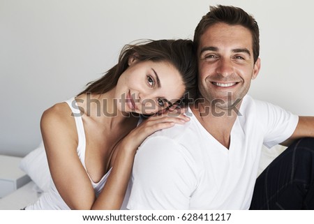 Good looking loving couple in bedroom, portrait
