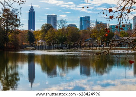 View of Lake Clara Meer, bridge with gazebo and Midtown Atlanta in sunny autumn day, USA
