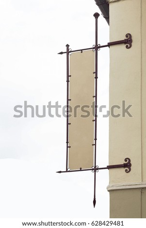 vertical front view of empty square signage with metallic frame on a building with classical architecture