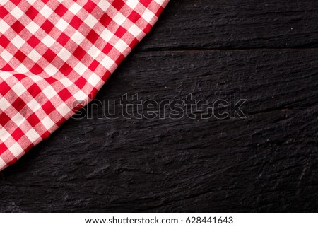 red table cloth on black wooden background