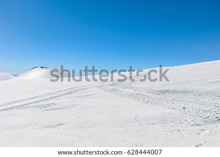 landscape of volcano crater covered with snow on mount etna