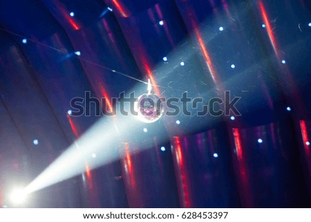 Disco ball and blue light ray on the stage