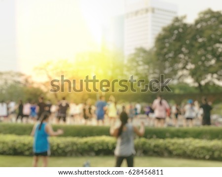 Blurred image background of summer activities with energetic people jogging, walking, running at green city park with bokeh light. Healthy lifestyle concept.