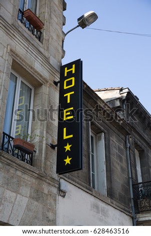 yellow and black sign with registered hotel in the street