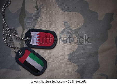 army blank, dog tag with flag of bahrain and united arab emirates on the khaki texture background. military concept
