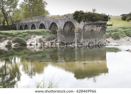 Bridge of the Roque. Old, ruined Bridge on the river in France, Normandy.