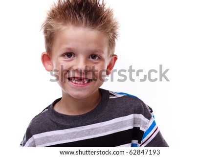 Cute little boy smiling and showing his missing teeth on a white background