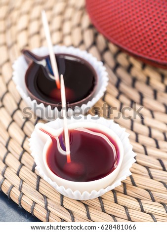 Ginja de Obidos, traditional sour cherry liquor, served in small cups made of chocolate. Royalty-Free Stock Photo #628481066