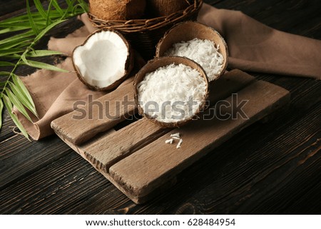 Grated coconut in shell on old wooden board