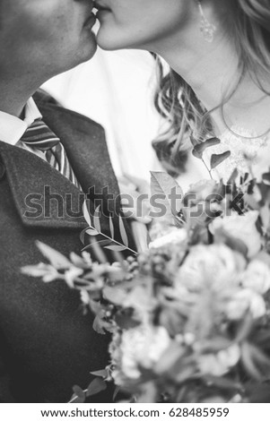 Bride and groom kiss black and white