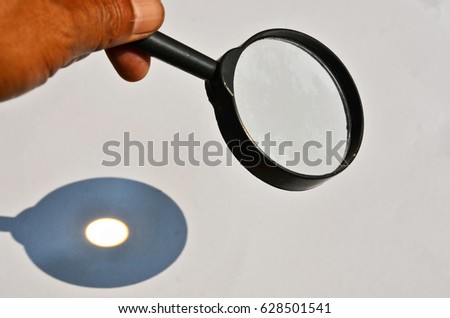 Light spot on white paper from burning glass