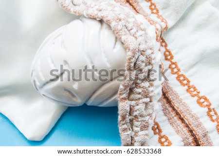 Concept photo of sleepy, tired or exhausted brain. 3D anatomical model of brain is sleeping on pillow nestled blanket. Illustration of heavy mental work, mental burnout in psychology and psychiatry