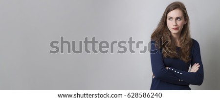doubt and worry concept - pouting young woman with long brown hair disliking with displeased body language, long banner with copy space Royalty-Free Stock Photo #628586240