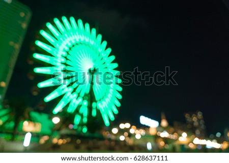 abstract blur bokeh night harbor lights background with ferris wheel