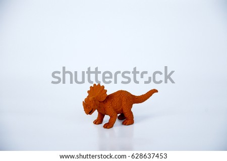 Triceratops model made from brown rubber isolated on white background.  
