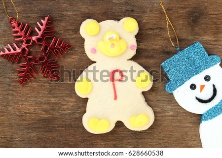 cartoon cookie with christmas decoration on wood background