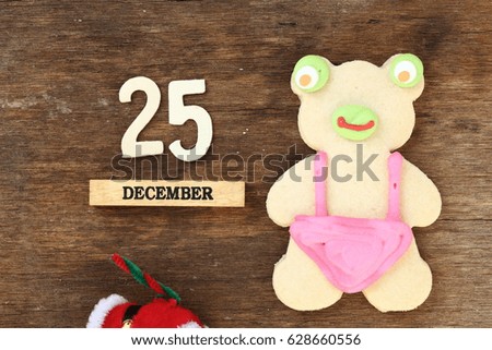 cartoon cookie with christmas decoration on wood background