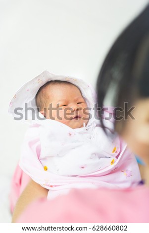 nurse is holding the baby carefully.