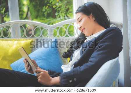 Happy asian business woman working with laptop computer in living room