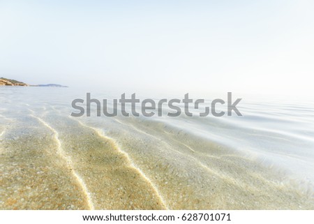 Soft wave of blue ocean on the sandy beach, background.