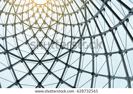 Structural glass facade curving roof of fantastic office building. Modern and Contemporary architectural fiction with glass steel column.Abstract architecture fragment. Royalty-Free Stock Photo #628732565