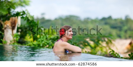 Panoramic photo of beautiful woman relaxing at swimming pool