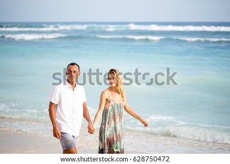 Content Couple Walking on Beach on Vacation