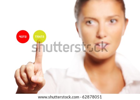 A modern picture of a young businesswoman touching the start button on the screen over white background, focus on hand