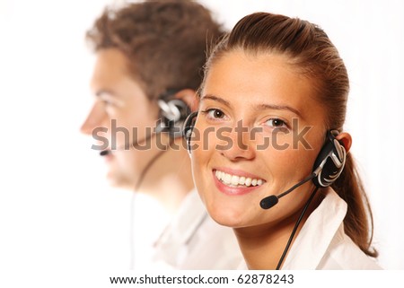 A picture of a team of young call center workers, pretty woman in the foreground