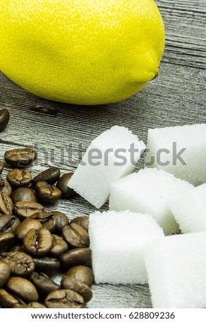 coffee grains,sugar and lemon on grunge wooden background