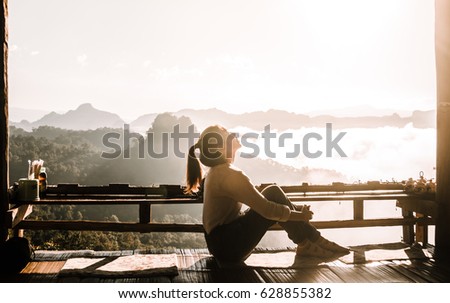 Young woman is catching the sunset.