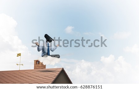 Faceless businessman with camera zoom instead of head sitting in lotus pose
