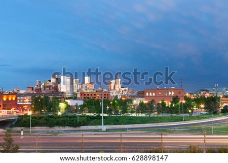 Sunset light reflects off the buildings of downtown Denver, Colorado