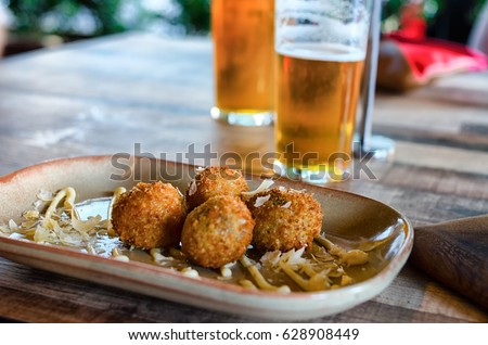 Arancini balls and glasses of beer