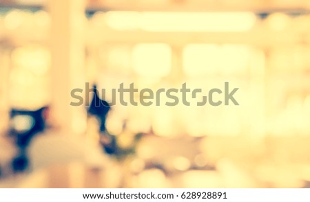 Abstract blur image of coffee shop or restaurant on day time with bokeh for background usage. (vintage tone)