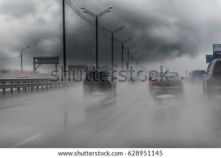 Picture of traffic on the freeway during a storm. Heavy rain on a road.