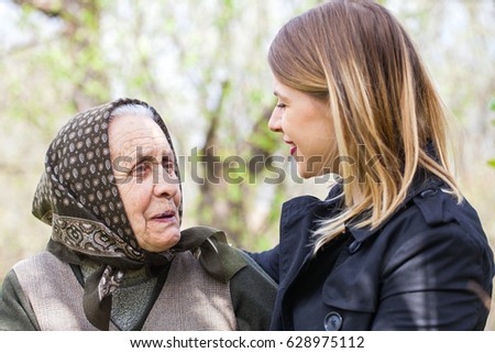 Picture of a beautiful woman spending time with her sick grandmother outdoor