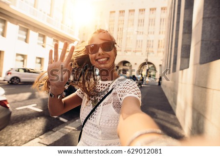 Tourist posing for a selfie in a street. Vlogger recording content for her travel vlog. Royalty-Free Stock Photo #629012081