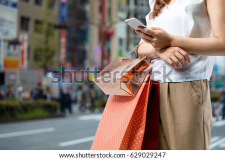 shopping concept. woman using smart phone with shopping bag.