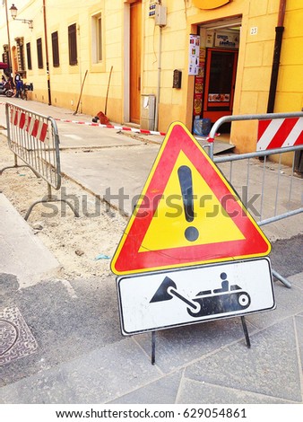 Yellow safety sign warns about roadworks