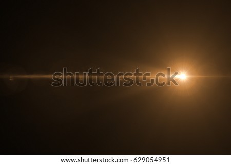 digital lens flare with bright light in black background used for texture and material Royalty-Free Stock Photo #629054951